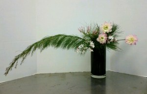 Hanging Nageire Variation #4. The brushy plant is a restio, and the flowers are pink dahlias highlighted with some touches of pink jasmine.